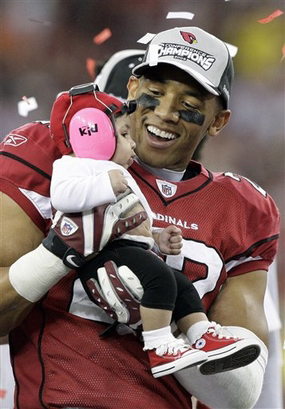 Matt Ware celebrates with his daughter Jaiden Elizabeth after the Cardinals' 32-25 win over Philadelphia in the NFC championship game in Glendale, Arizona. Photo: Ross D. Franklin/AP